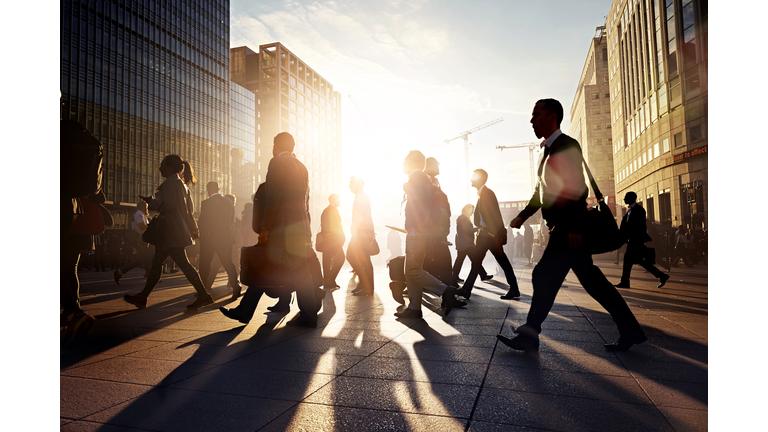 Employees walking to work in the city at sunrise