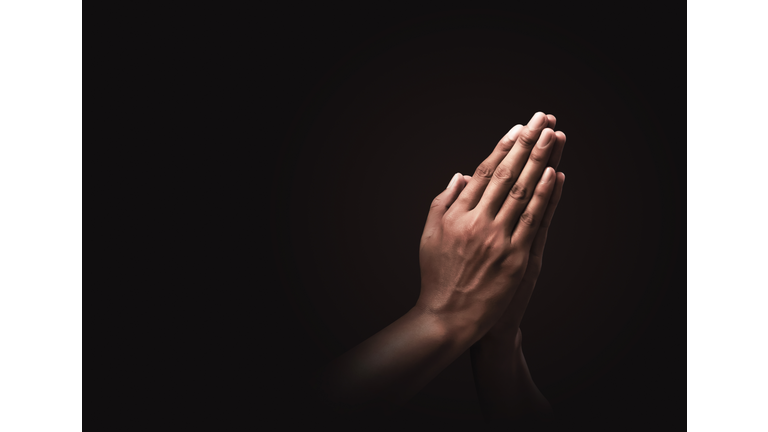Praying hands with faith in religion and belief in God on dark background. Power of hope or love and devotion. Namaste or Namaskar hands gesture. Prayer position.