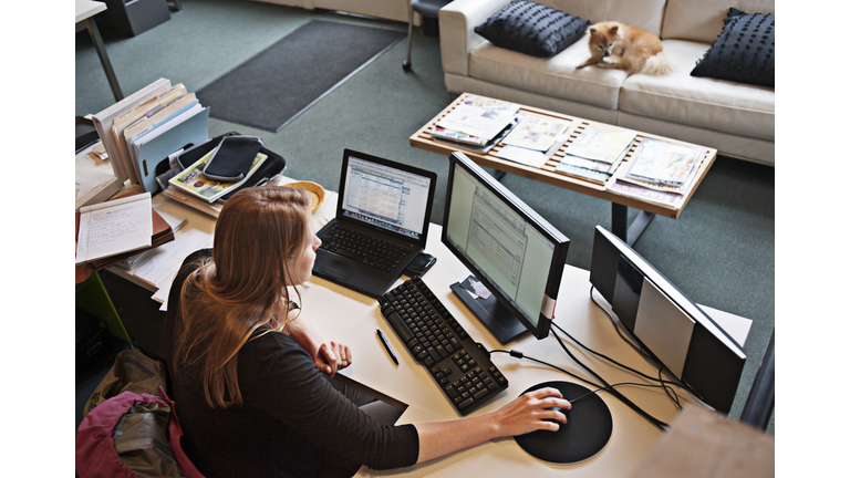 Overview of woman working at office computer