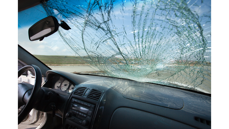 Inside of car with the broken windshield. Road accident