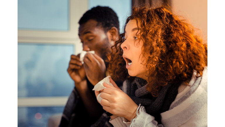 Woman feeling awful while sneezing and having running nose