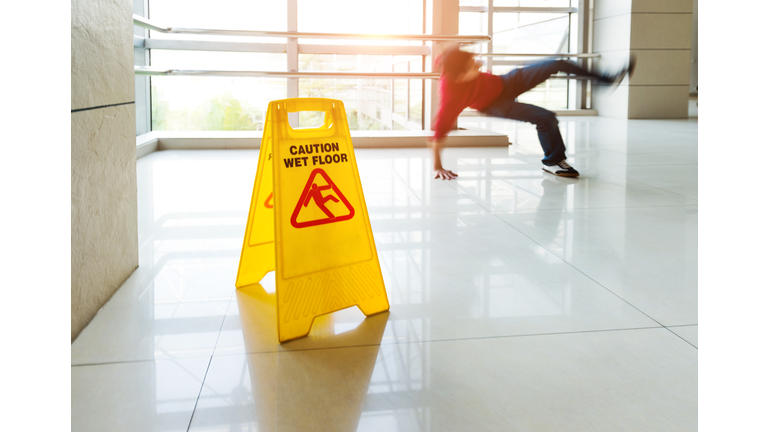 Man slips falling on wet floor