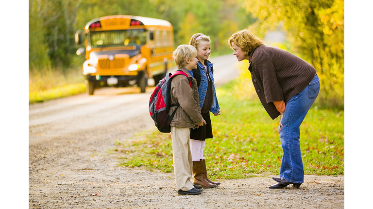 Mother and Children Waiting for a School Bus