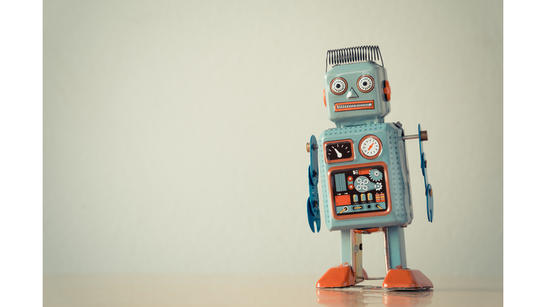 Close-Up Of Robot On Table Against Wall