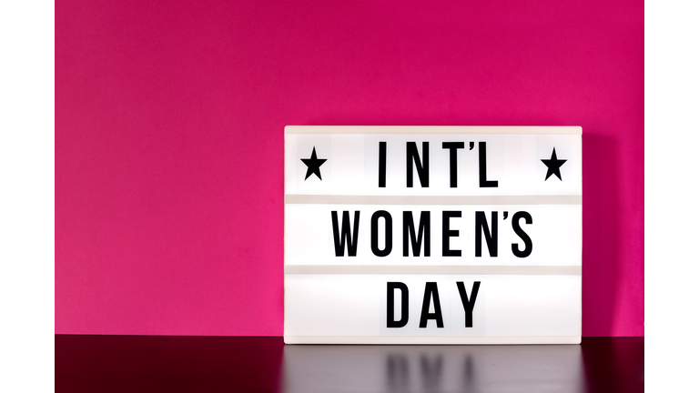 Close-Up Of Womens Day Sign Against Pink Wall