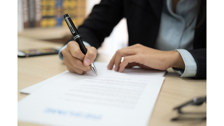 Woman signing job contract