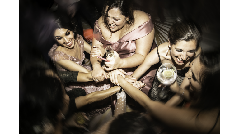 High angle view of bride and bridesmaid with hands together