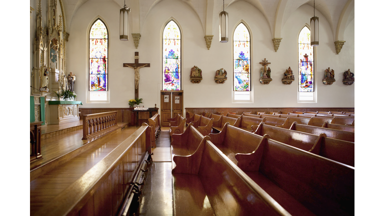 Pews and stained glass windows in church