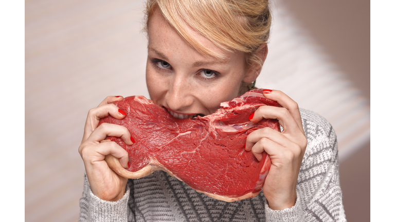 Woman eating steak