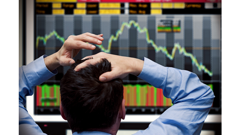 Trader watching stocks crash on screen