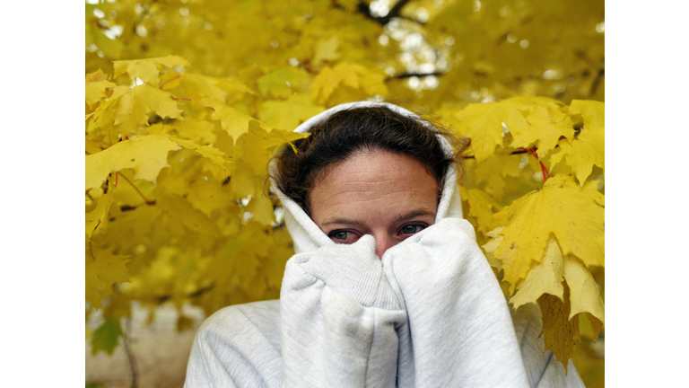 Woman wearing hooded sweatshirt, closeup, autumn