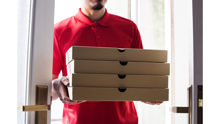 Man delivery pizza to customer