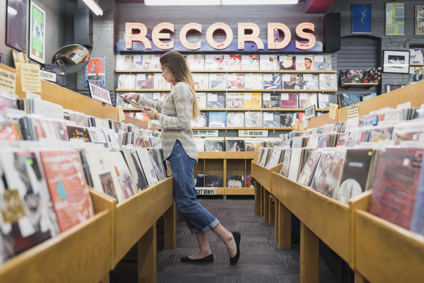 Teenage girl in record store shopping for music