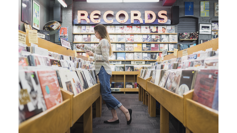 Teenage girl in record store shopping for music