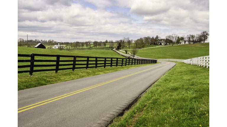 Winding two-lane rural road in bluegrass region of Kentucky