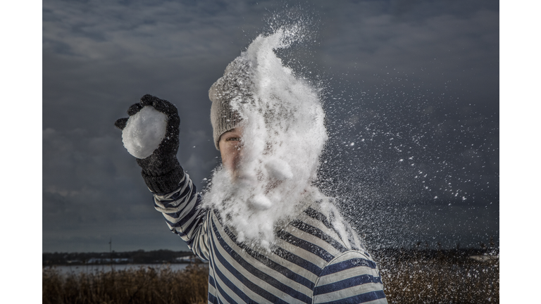 Man getting hit by snowball in the face