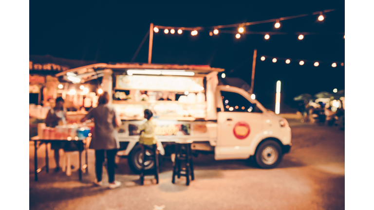 Defocused Image Of People By Food Truck At Night