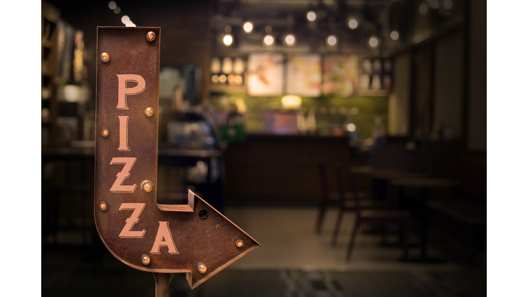 Pizza shop signboard, in front of the store
