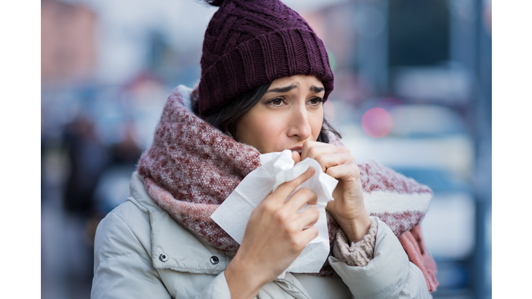 Woman coughing in winter
