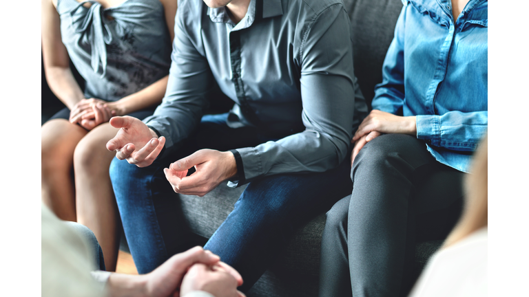 Counseling and conversation in group therapy or meeting. Man sharing story to community. Casual business people in discussion. Peer support, trust and empathy.