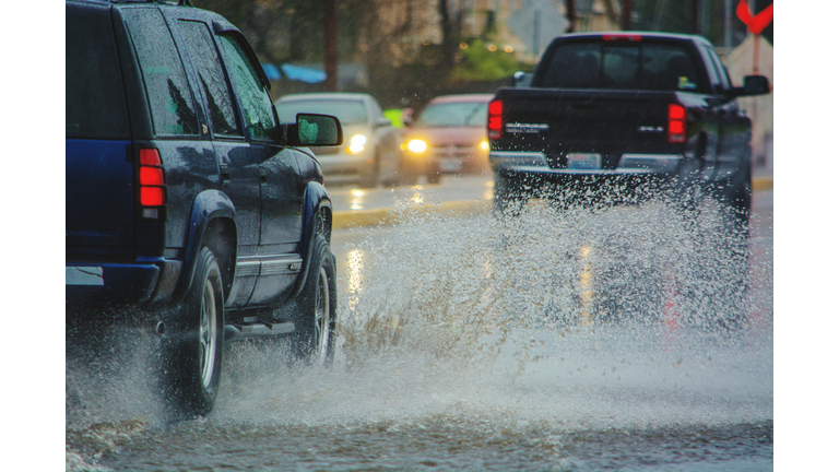 Cars Splashing Water On Road In Rainy Season