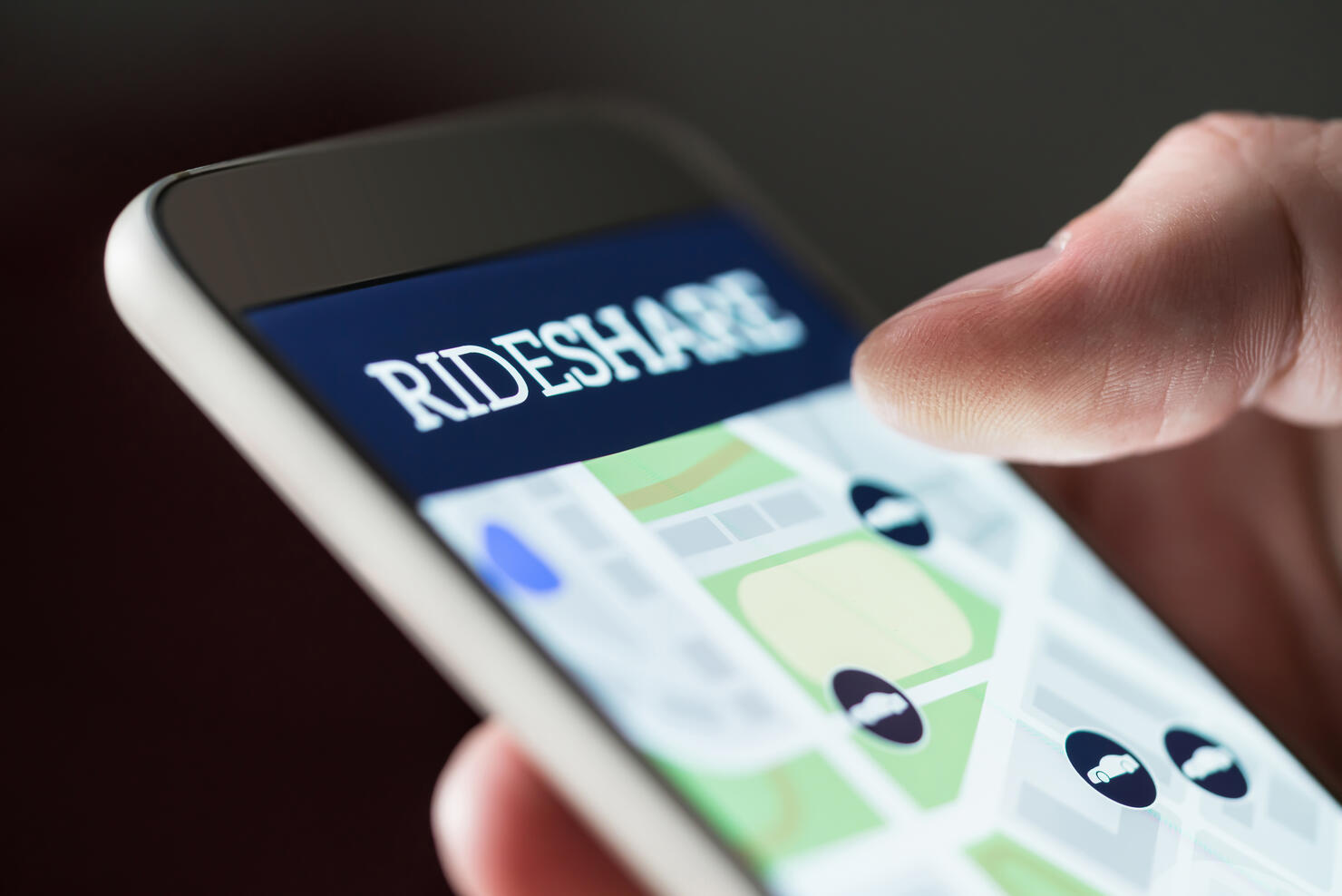 Ride share app in smartphone. Man using rideshare taxi application. Online carpool or carsharing service in mobile phone.