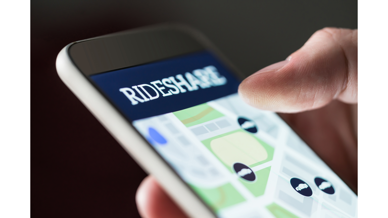 Ride share app in smartphone. Man using rideshare taxi application. Online carpool or carsharing service in mobile phone.