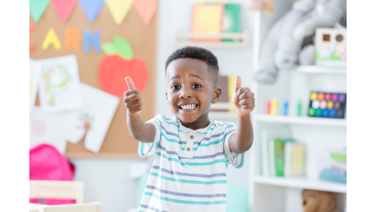 Little boy gives new day care center two thumbs up