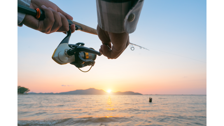 Fishing on the lake at sunset. Fishing background