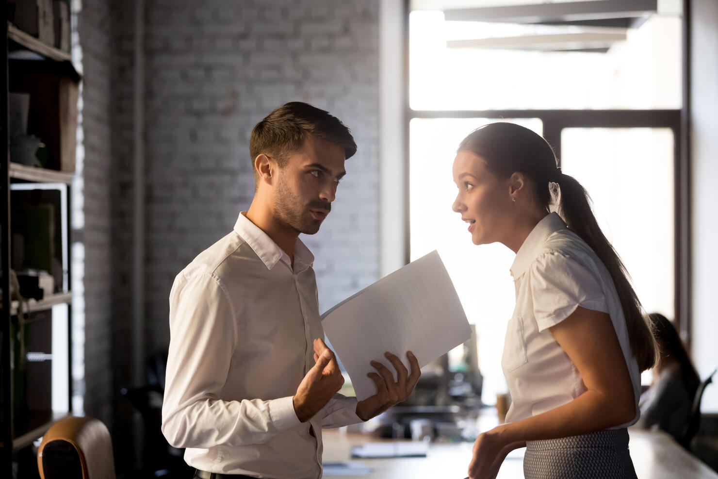 Diverse employees argue over financial report in office