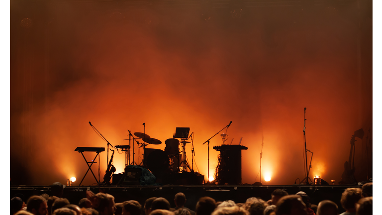 empty concert stage on music festival, instruments silhouettes