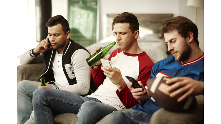 Men using mobile phone during commercial break. Debica, Poland