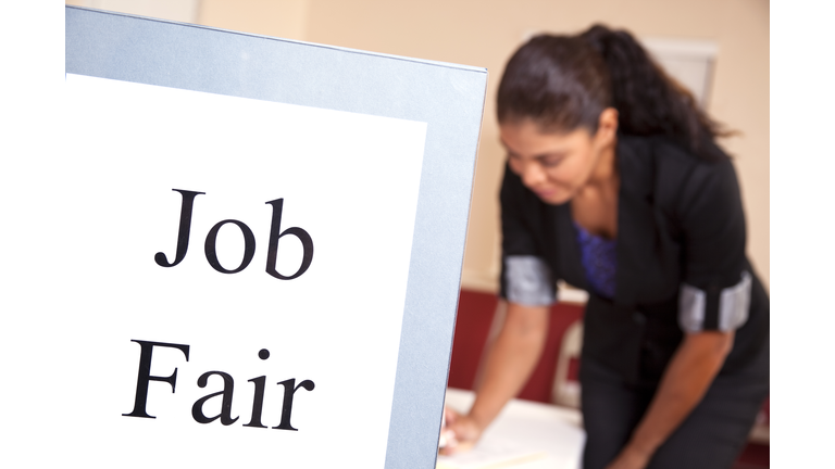 Latin woman at Job Fair registration table.