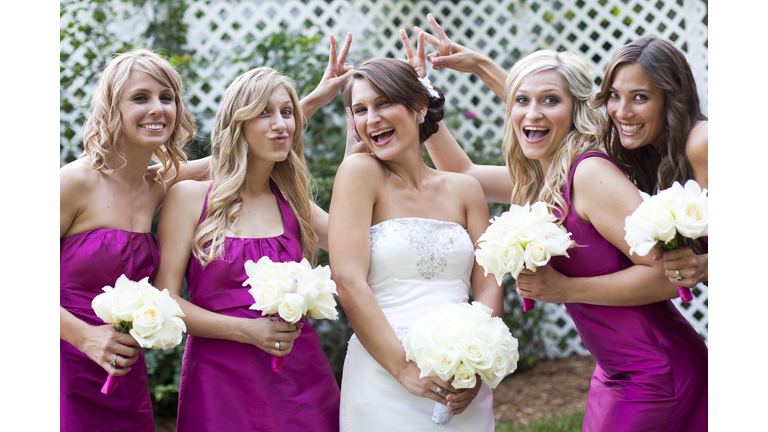 Bride posing with her bridesmaids.