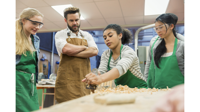 Carpentry teacher and students working in workshop