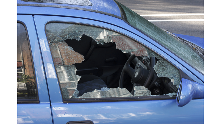 Window smashed by car thief street scene