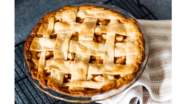 Apple pie with latticed pastry on kitchen counter