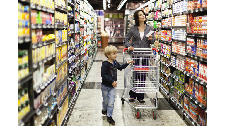 Woman grocery shopping with son