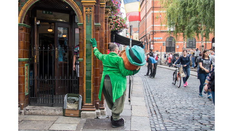 Leprechaun mascot taking a break in Dublin