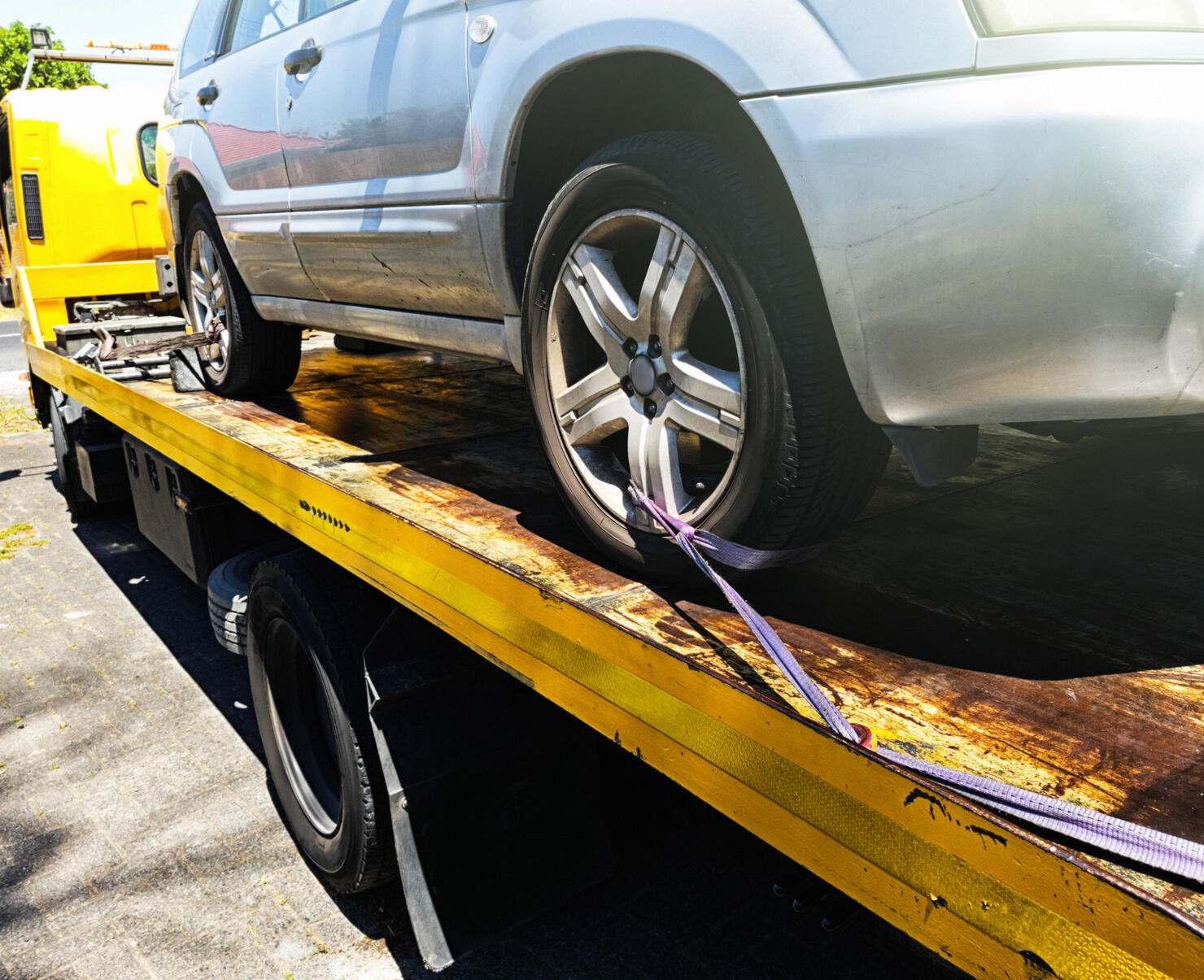 Car being attached to tow truck