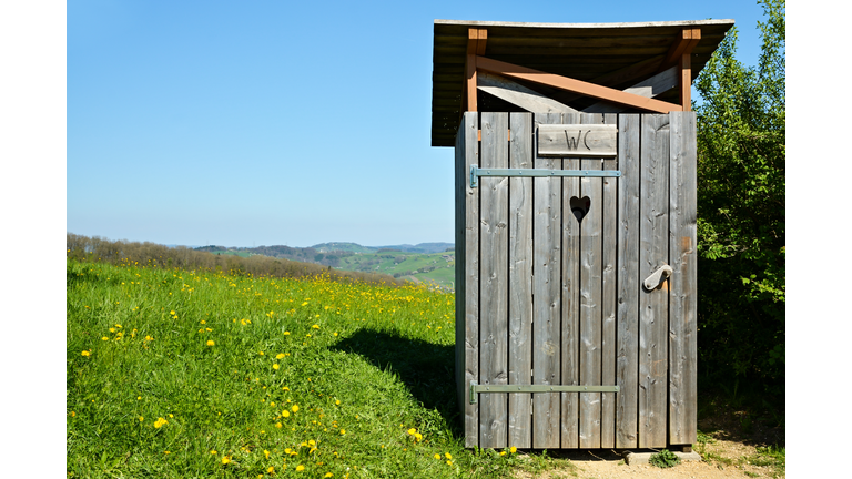 Wooden outhouse in the middle of park