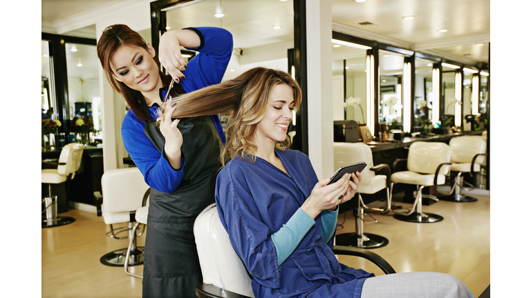 Woman having hair cut in salon