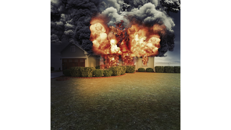 House fire, wooden home in flames, fully ablaze with thick smoke