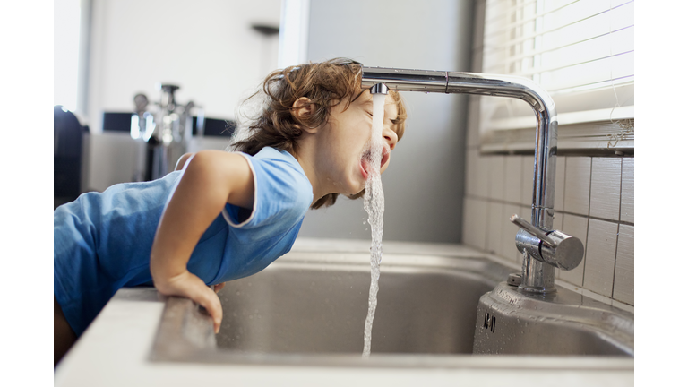 Small boy drinking water