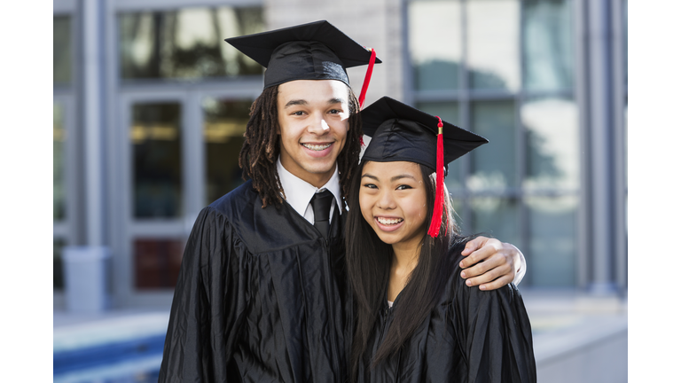 Portrait of two friends graduating from school