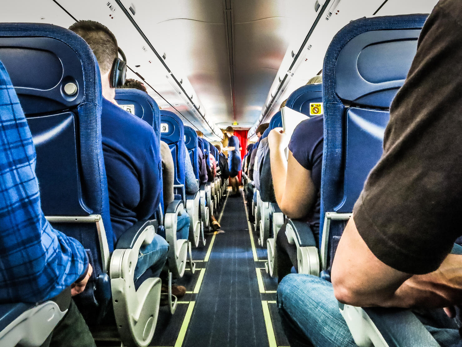 Rear View Of People Sitting In Airplane