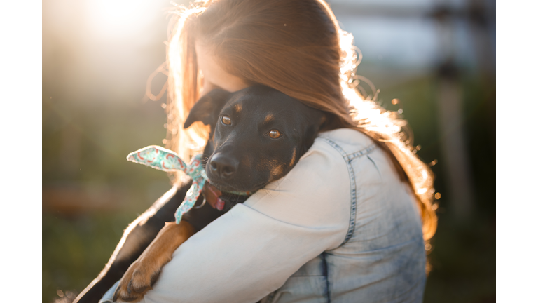 Girl hugging her dog