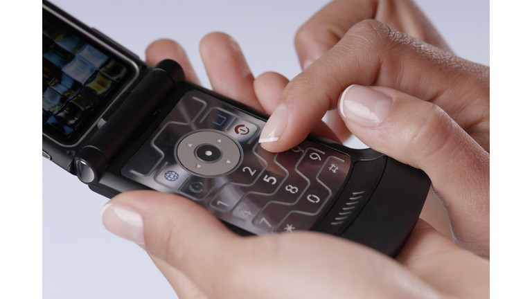 Close-up of a woman's finger using a mobile phone