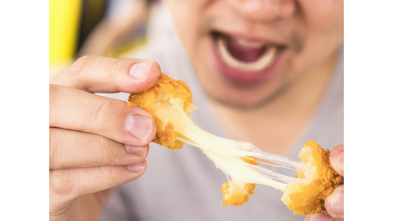 Midsection Of Man Eating Food