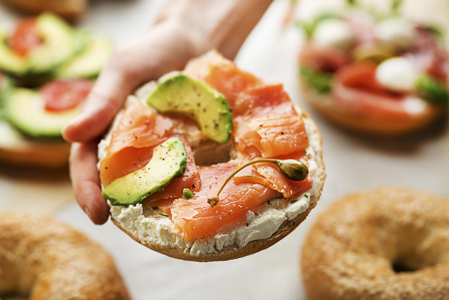 Holding healthy bagel sandwich